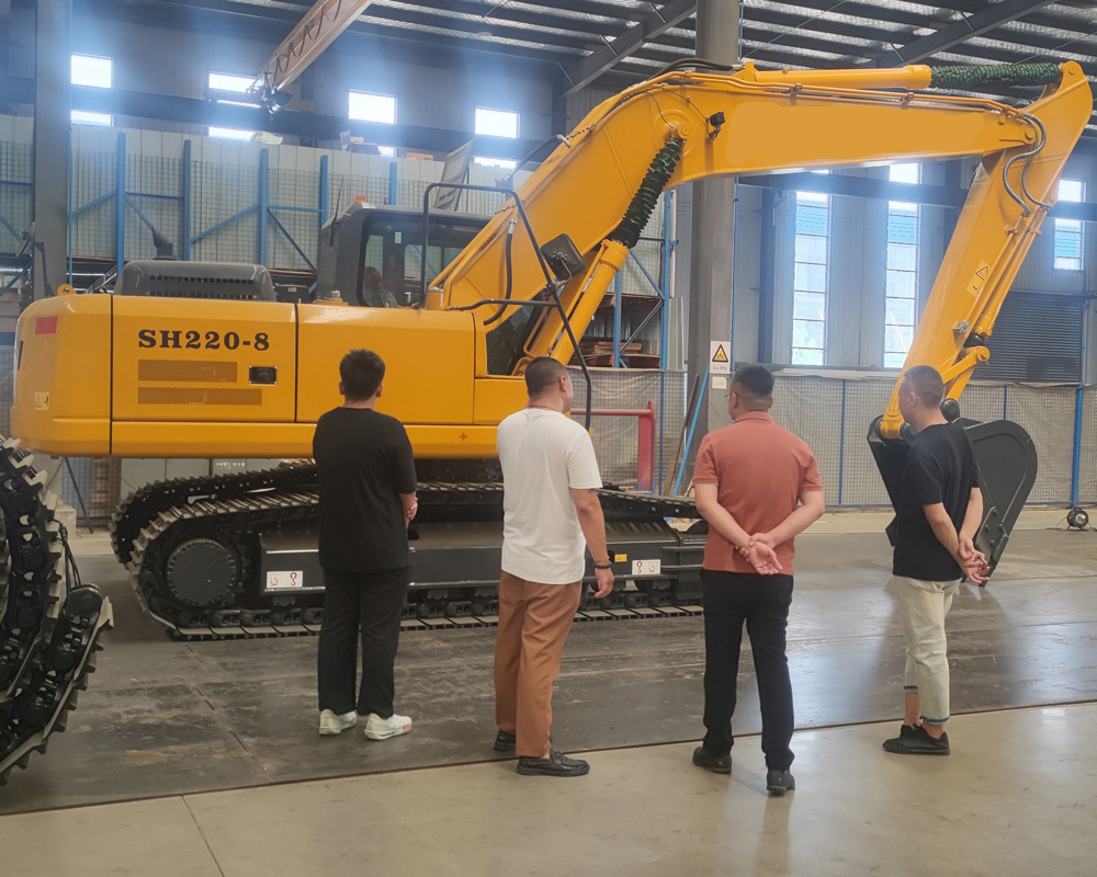 SHANBO SH220 field-deployment on quarry site — arm extended, heavy-duty LC track frame, cab-mounted LCD console